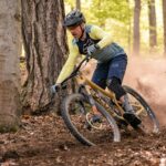 A man riding a mountain bike through a forest